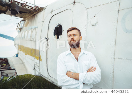 a man on the background of an old plane 44045251