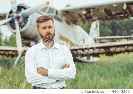 a man on the background of an old plane a man on the background of an old plane 44045263