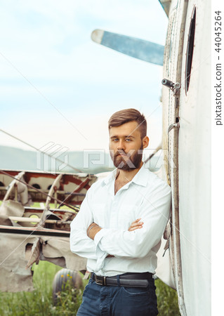 a man on the background of an old plane a man on the background of an old plane 44045264
