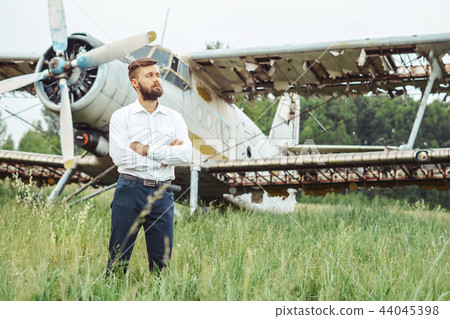 a man on the background of an old plane a man on the background of an old plane 44045398