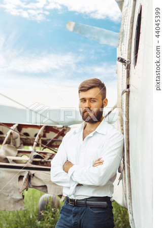 a man on the background of an old plane a man on the background of an old plane 44045399