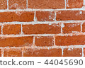 Old brick wall texture of red stone blocks closeup 44045690