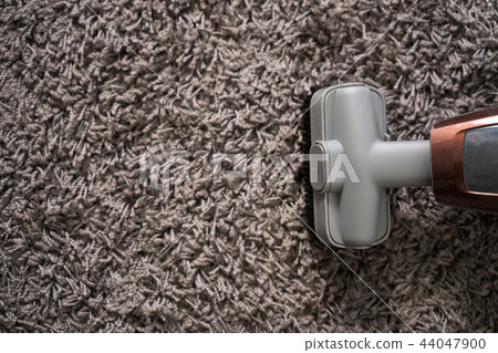 Close-up Of man using A Vacuum Cleaner Close-up Of man using A Vacuum Cleaner 44047900