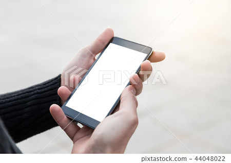 Man uses his mobile phone outdoor. 44048022