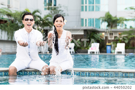 Couple enjoying on swimming pool Couple enjoying on swimming pool 44050202