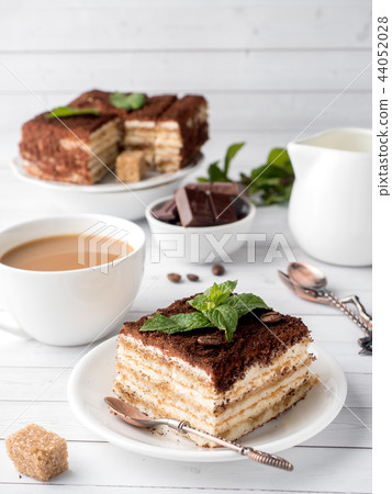 Tiramisu Dessert with Mint and Cup of Coffee Tiramisu Dessert with Mint and Cup of Coffee 44052028