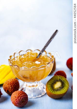 Jam of tropical fruits on a wooden table. 44052564