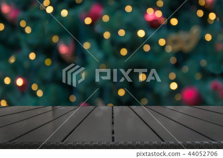 Wooden dark tabletop and blurred christmas bokeh. Wooden dark tabletop and blurred christmas bokeh. 44052706