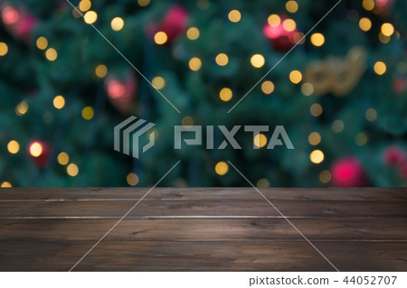Wooden dark tabletop and blurred christmas bokeh. Wooden dark tabletop and blurred christmas bokeh. 44052707