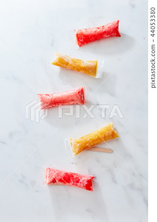 Freezer tubes with zip seals for healthy snacks juice and fruit smoothies on a marble bacground Freezer tubes with zip seals for healthy snacks juice and fruit smoothies on a marble bacground 44053380