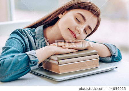 Amazing brunette leaning on pale of her books Amazing brunette leaning on pale of her books 44054913
