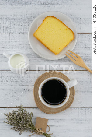 A cup of coffee, milk and butter cake 44055120