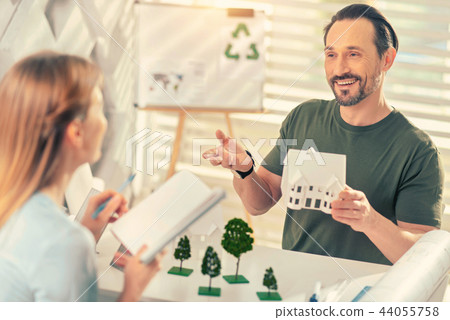 Cheerful brunette man having friendly talk during pause Cheerful brunette man having friendly talk during pause 44055758