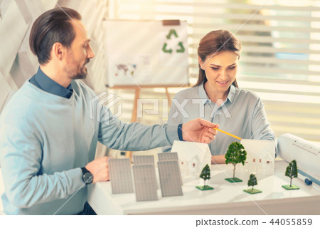 Concentrated woman creating model of comfort building 44055859