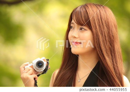 A woman taking a picture 44055955