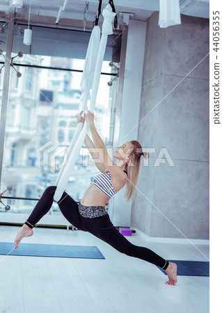 Calm confident woman developing strength during yoga 44056355