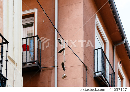 Shoes hanging on wire in Lavapies in Madrid Shoes hanging on wire in Lavapies in Madrid 44057127