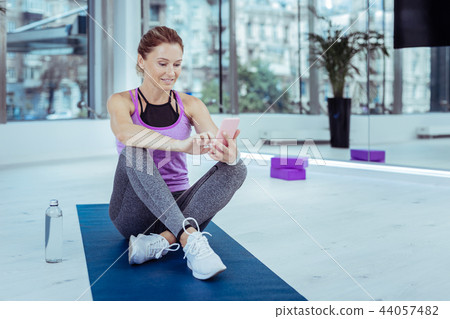 Thoughtful mature woman publishing photo from training 44057482