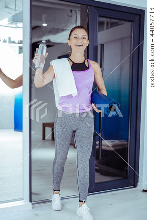 Exuberant mature woman preparing for exercises in gym Exuberant mature woman preparing for exercises in gym 44057713
