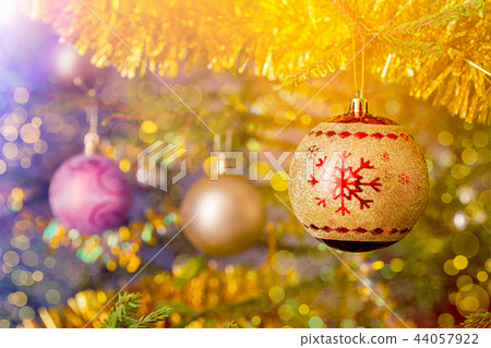 Christmas-tree decoration bauble on decorated Christmas tree bac Christmas-tree decoration bauble on decorated Christmas tree bac 44057922