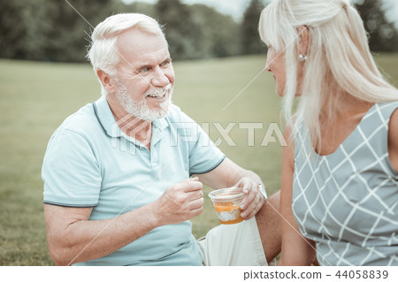 Pleased bearded male listening to his partner 44058839