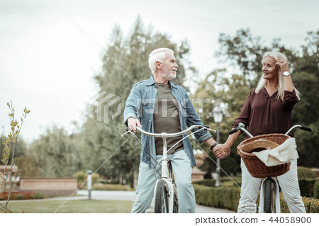 Relaxed senior female person touching her hair 44058900