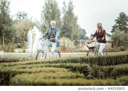 Cheerful blonde woman following her mature partner 44058903