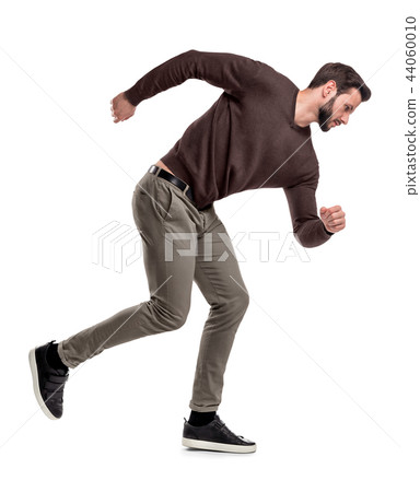 A fit bearded man in casual sweater stands in a mid-running position with arms wide helping to gain 44060010