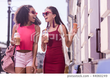 Joyful positive woman pointing at the shop window Joyful positive woman pointing at the shop window 44060249