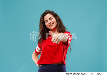 The happy business woman standing and smiling against blue background. The happy business woman standing and smiling against blue background. 44060516