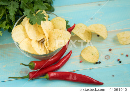 Potato chips with spicy in a glass bowl Potato chips with spicy in a glass bowl 44061940
