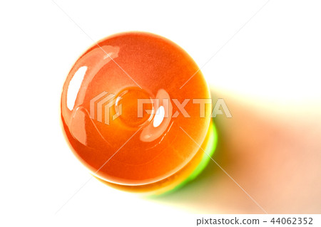 The Orange lollipop on a white background The Orange lollipop on a white background 44062352