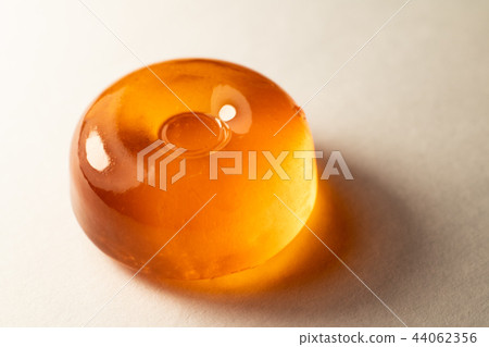 The Orange lollipop on a white background The Orange lollipop on a white background 44062356