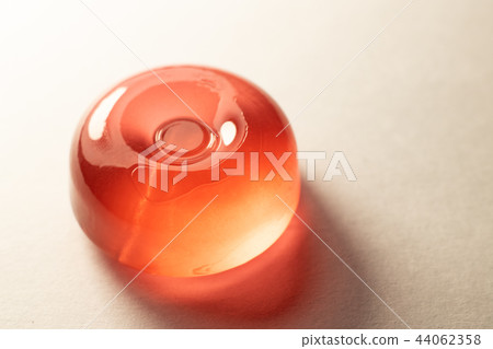 The Orange lollipop on a white background The Orange lollipop on a white background 44062358