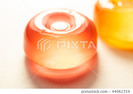 The Orange lollipop on a white background The Orange lollipop on a white background 44062359