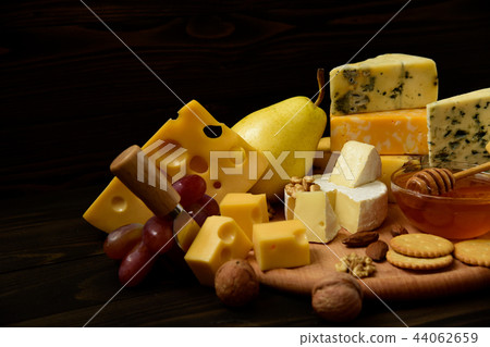 Various types of cheese on a rustic wooden table Various types of cheese on a rustic wooden table 44062659