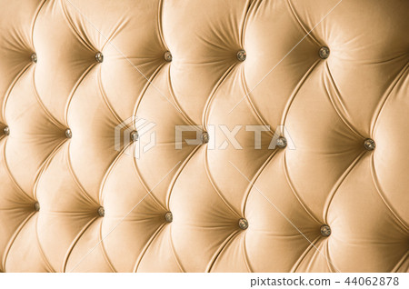 Beige soft textile background with symmetrical buttons on the corners of diamonds. Soft and 44062878