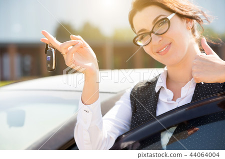 Young business woman portrait in her car Young business woman portrait in her car 44064004