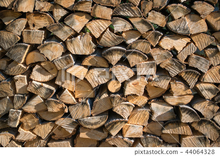 Cut split stacked firewood for winter background close-up Cut split stacked firewood for winter background close-up 44064328