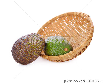 whole fresh avocado in bamboo basket and on white whole fresh avocado in bamboo basket and on white 44065518