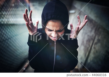 Angry teenage girl standing at school campus 44068316