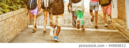 Rear view of classmates running at school campus Rear view of classmates running at school campus 44068612