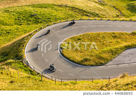 Motorcycle drivers riding in Alpine highway on famous Hochalpenstrasse, Austria, Europe. 44068693