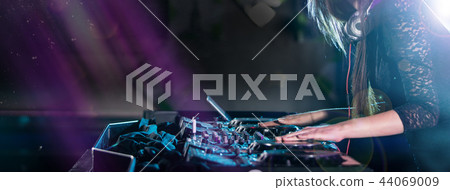 Dj mixes the track in the nightclub at a party Dj mixes the track in the nightclub at a party 44069009