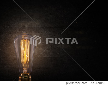 Vintage Edison light bulb on dark background. 44069050