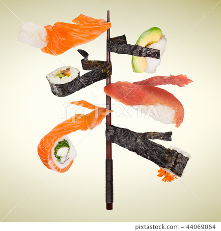 Pieces of delicious japanese sushi frozen in the air. 44069064