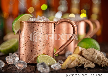 Cold Moscow Mules - Ginger Beer, lime and Vodka on bar 44069206