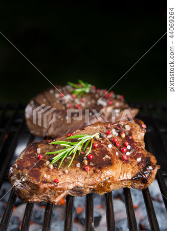 Beef steaks on the grill with flames Beef steaks on the grill with flames 44069264