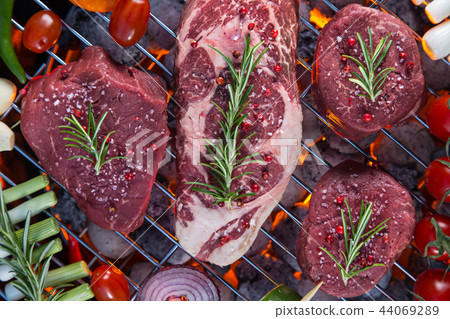 Barbecue grill with beef steaks, close-up. 44069289