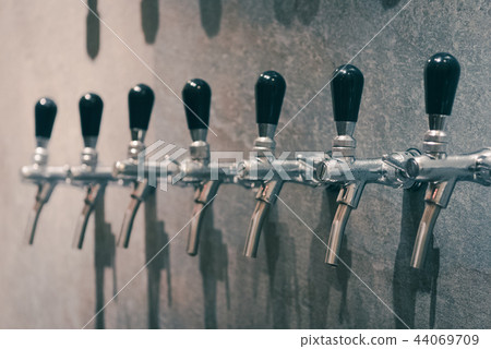 silver beer dispenser, selective focus silver beer dispenser, selective focus 44069709